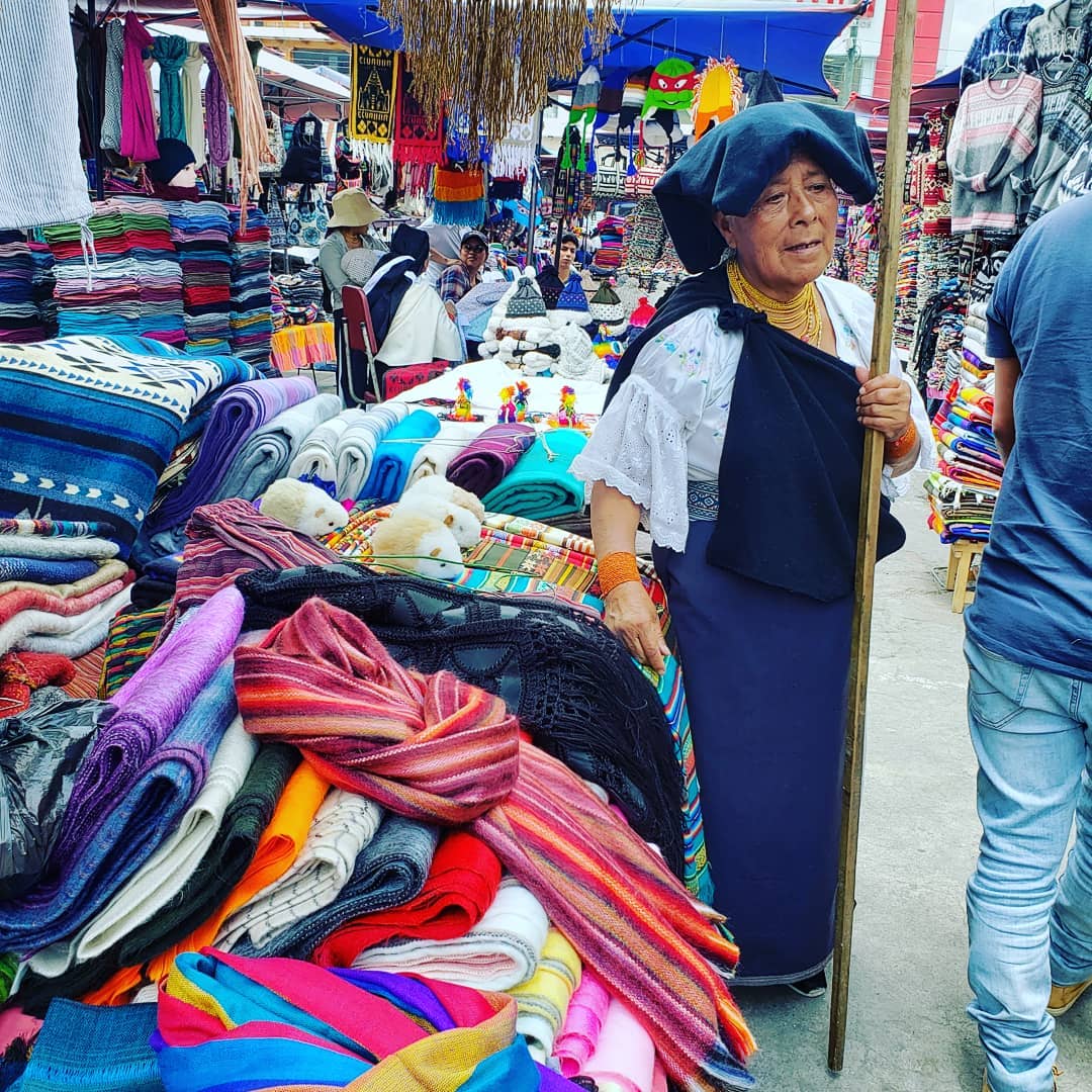 An indigenous Ecuadorian woman selling goods at the market in Otavalo, Ecuador.