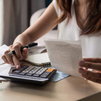 Woman working on her budget with calculator