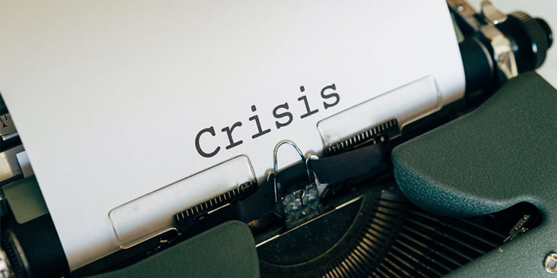 typewriter paper with crisis as text