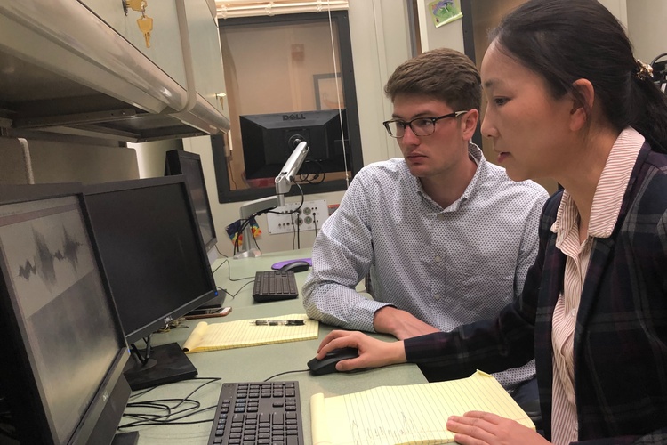 Professor Jin Yang (right) works with a student in the Speech Acoustics & Development laboratory, which works to help people who struggle with speech-language-hearing impairments and the speech intelligibility for people who have difficulties with a second language.