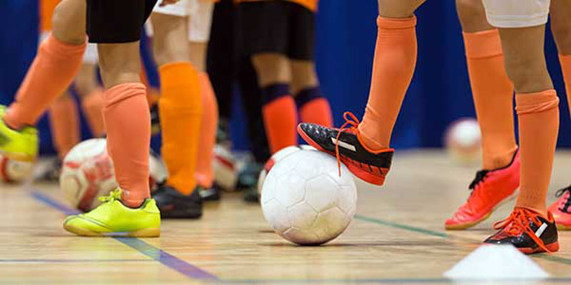 Close up of soccer players playing indoors