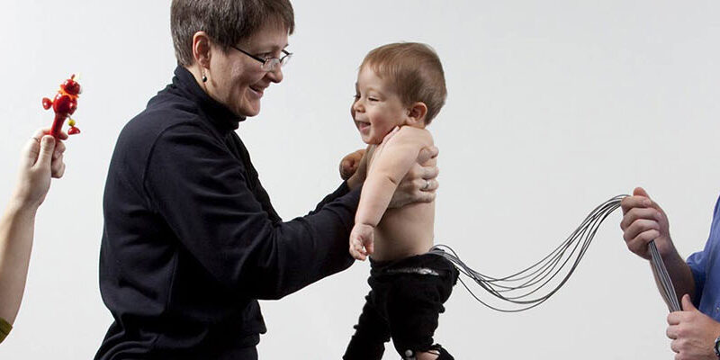 Physical therapy of an infant with parents and practitioner