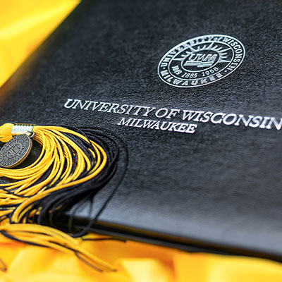 UWM Diploma cover with a tassel