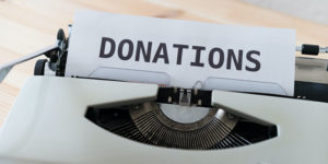 typewrite with "donation" on paper