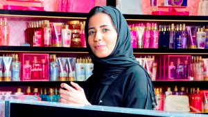 Muslim woman working at store counter
