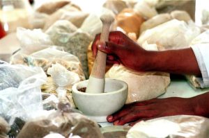 Medicine being ground in mortar and pestle