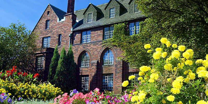 UWM campus building - Chapman Hall - summer with flowers in front