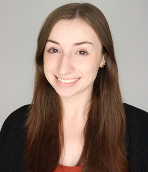 Front-facing portrait of Allison Hecker, smiling, with shoulders partially visible.