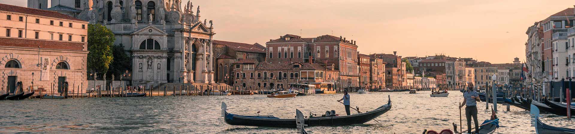 Gondolas along river in Venice Italy