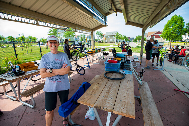 Anne Dressel at Westlawn picnic area with bike repair in back