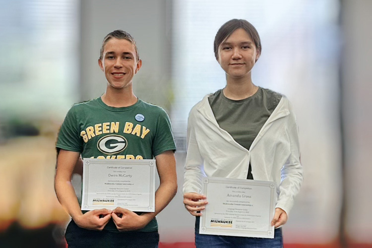 Summer interns smile while holding their UW-Milwaukee Certificates of Completion side by side.
