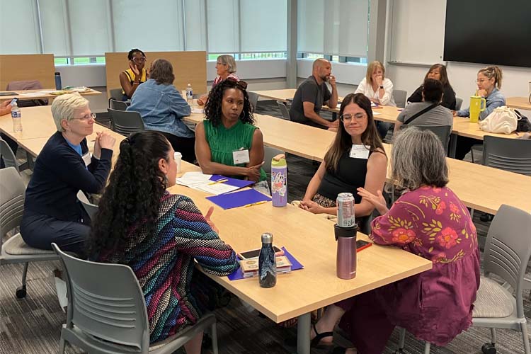 teachers discussing ideas around a table