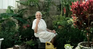 an elderly person sitting in a garden