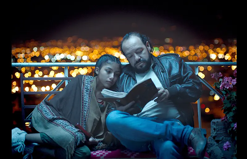 one person reading a book to another