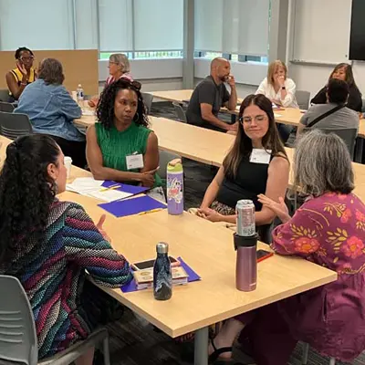 teachers having discussions around table.