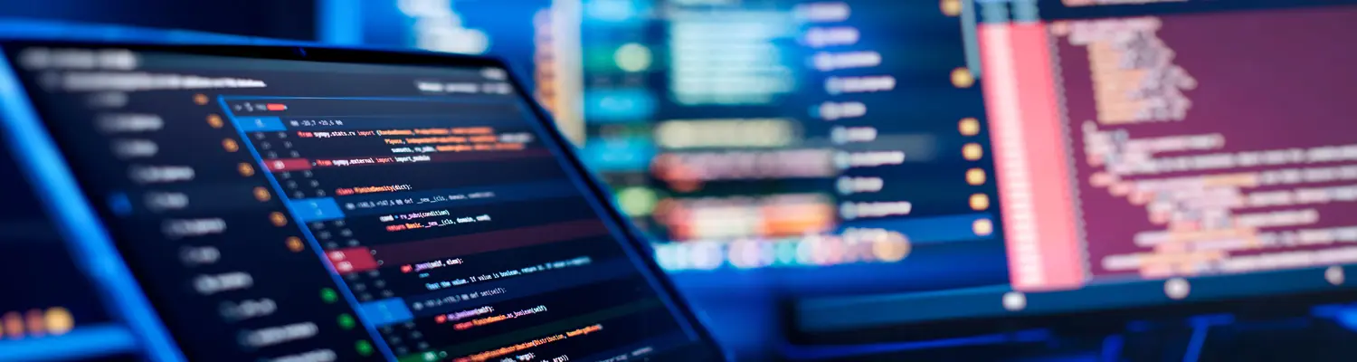 tablet and monitors showing computer code