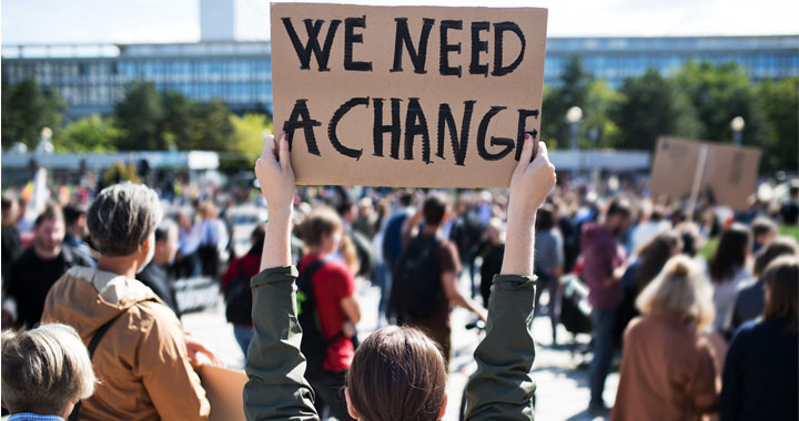 group of people with sign for change