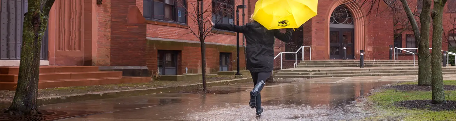 student walking with umbrella