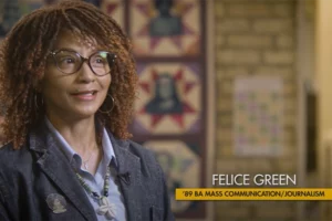 A Black woman with black glasses and curly reddish-brown hair smiles in front of a patterned background. A gold chiron to the right says "Felice Green, '89 BA Mass Communication/Journalism."