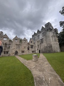 An old castle with several pointed gables, constructed from whitish stone.