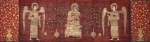 An image of a red cloth embroidered with golden vines on either end of the cloth. In the middle is an embroidered image of two angels looking toward a central holy figure while a small knight prays at the figure's feet.