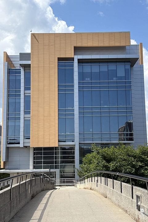 A large rectangular building with several banks of vertical glass windows.