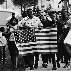 Marchers carrying American flag
