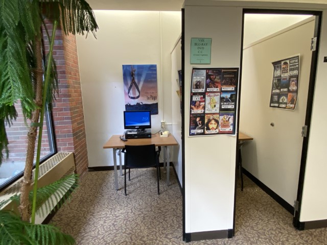 Image of two semi-enclosed study rooms. They have walls, but no door. The first room has video viewing equipment.
