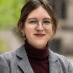 A woman wears glasses,