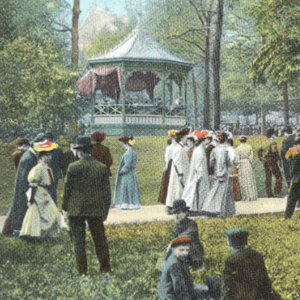 Individuals in historical clothing mingle around an outdoor gazebo.