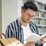 person reading book in library