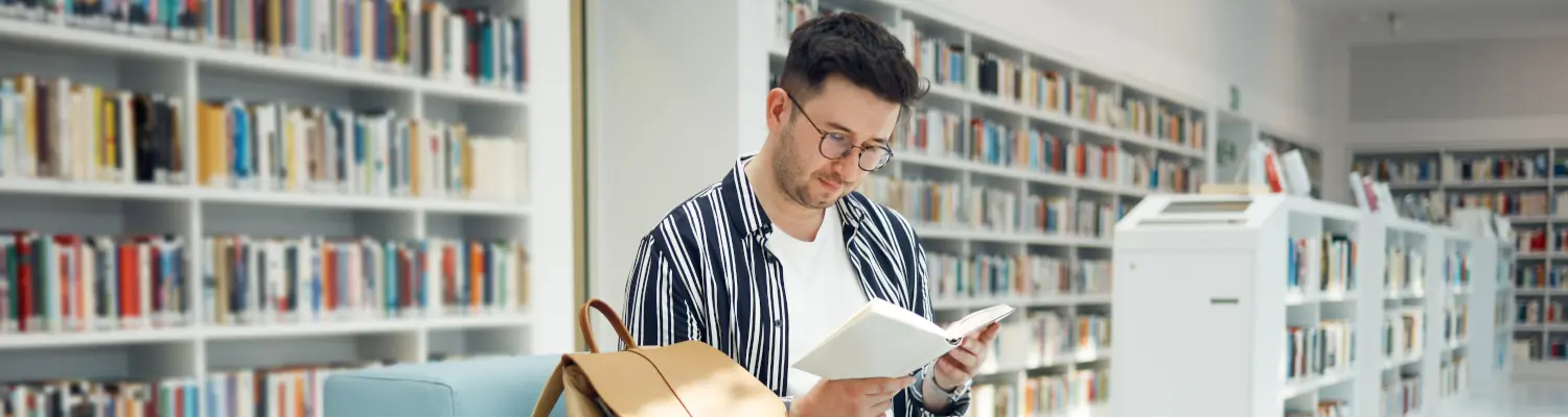person reading book in library