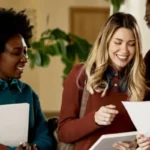 students gathered around a looking at papers