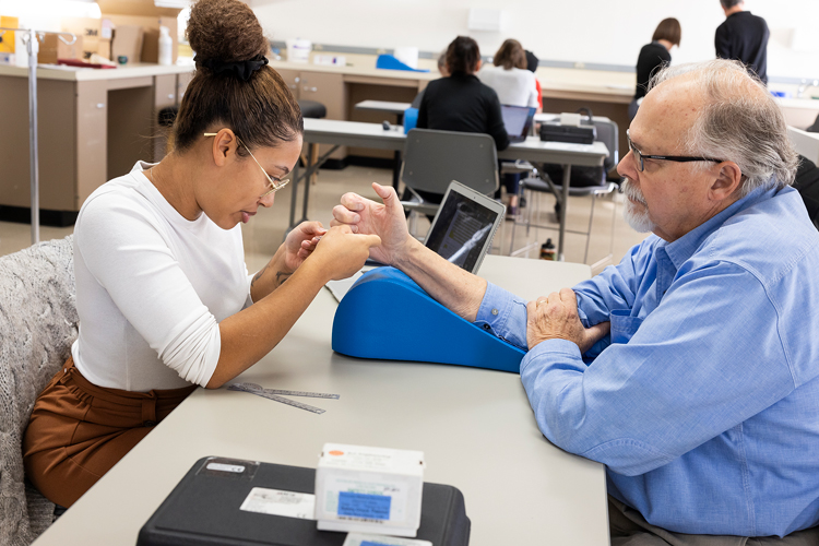 Occupational therapy student evaluates a client.