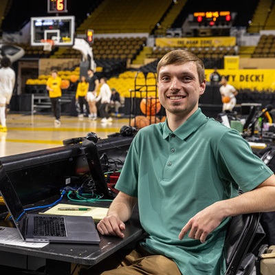 Data science masters student Josh Rady monitors real-time data during a basketball game