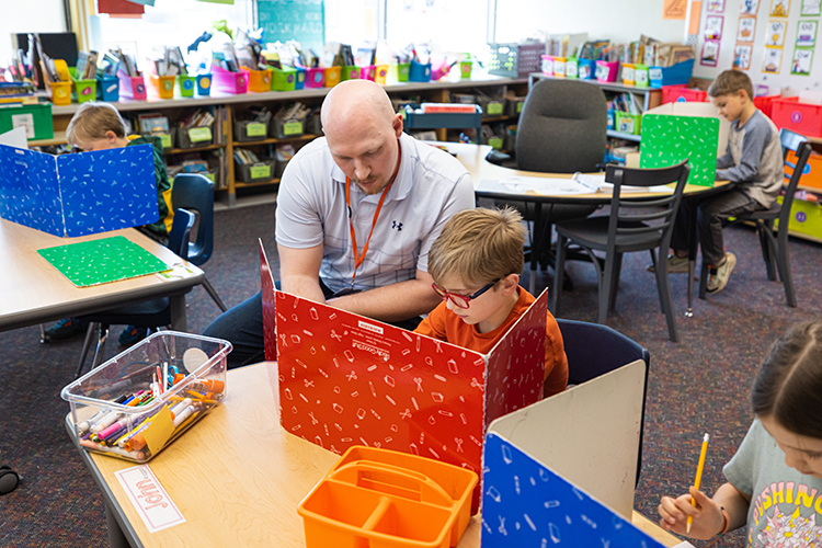 Tannar Thompson working with a student during his student teaching experience.