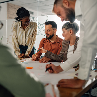 A group of professionals discussing topics and working together in a conference room