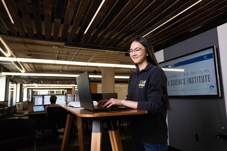 Data science student Cameron Lee works on her laptop at the Northwestern Mutual Data Science Institute.