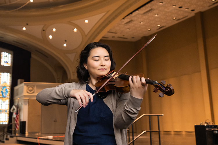 A UWM music student playing the violin.