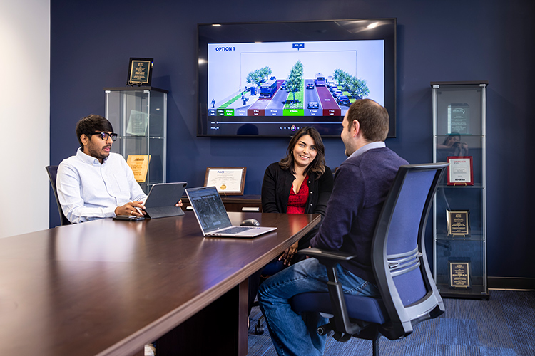 Master of Urban Planning student Cinthia working at her internship with two colleagues