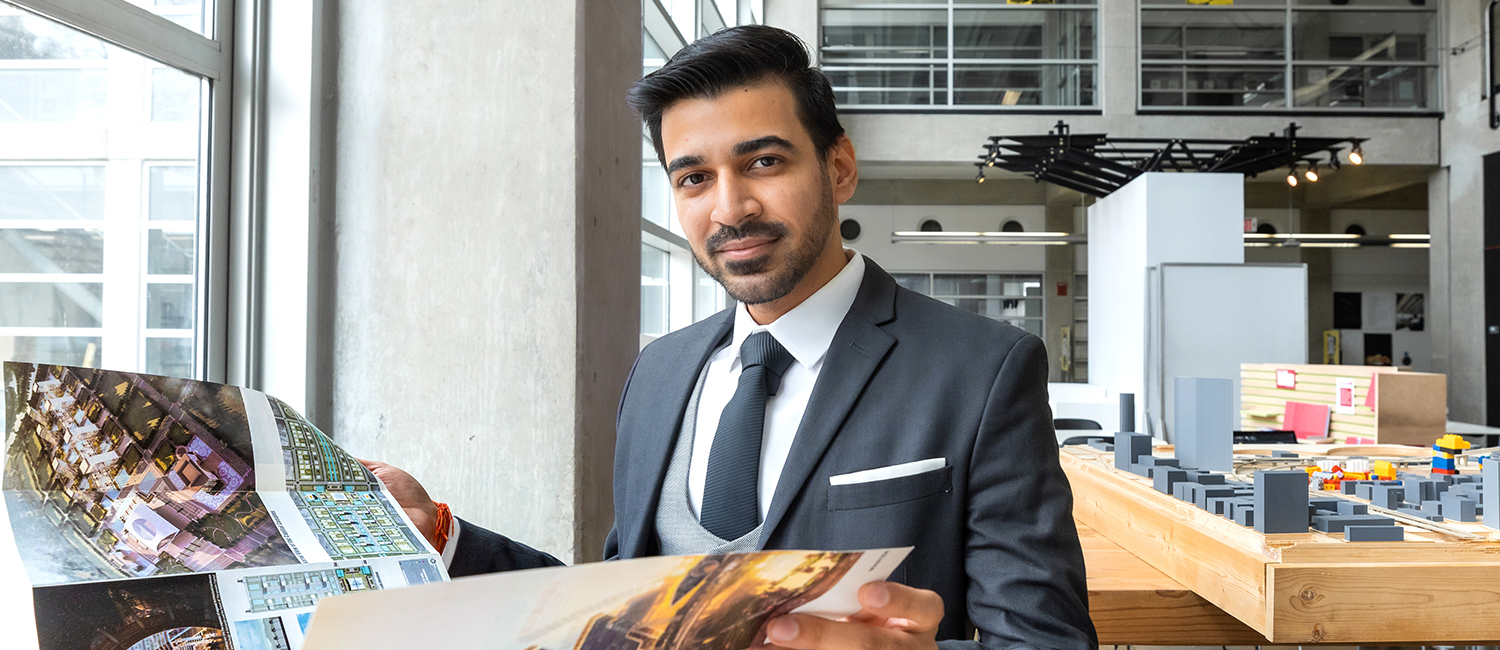 Master of Urban Planning student, Yash looking through one of his projects.