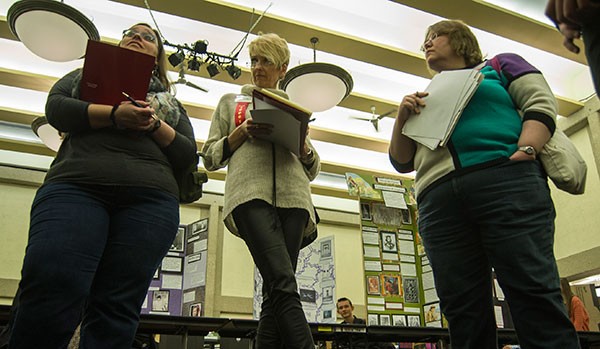 Judges Kathy Kruger, Maryann Sander and Melissa Waalstad evaluate students’ presentations