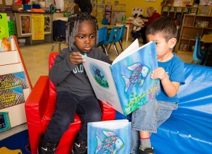 Students at the Guadalupe Head Start Center enjoy reading about “Rainbow Fish,” in English and Spanish. (UWM photo by Derek Rickert)