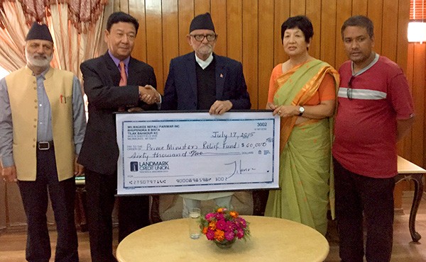UWM professor Kalyani Rai, second from right, recently presented a check for $60,000 to Nepal’s prime minister Sushil Koirala, third from right – money raised in Milwaukee for earthquake relief. (Photo/courtesy of Kalyani Rai)