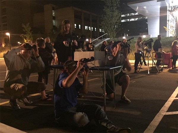 Nearly 200 people gather at UWM to watch a rare lunar eclipse.