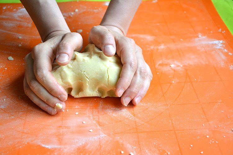 Process of making a dough from farina and butter on orange silicone pad