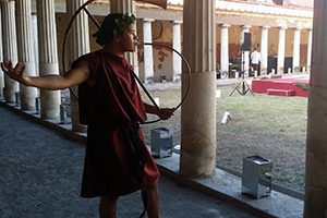 Taylor Layton breaks for a moment of levity to demonstrate a Roman trumpet in the courtyard of Villa Oplontis at the Ancient Stabiae site in Italy. (Photo courtesy of Taylor Layton)