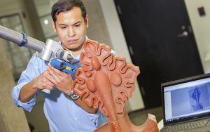 Taylor Layton works with a 3-D scanner in a lab at UWM. (UWM Photo/Pete Amland)