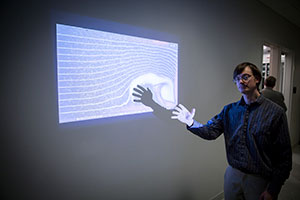 Tom Hansen demonstrates computational fluid dynamics software he developed to show the interactions of users with the flow fields.