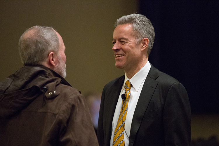 Chancellor Mark Mone chats with Mark Schwartz, distinguished professor of geography, before beginning his spring plenary address at the Helene Zelazo Center for the Performing Arts. (UWM Photo/Troye Fox)